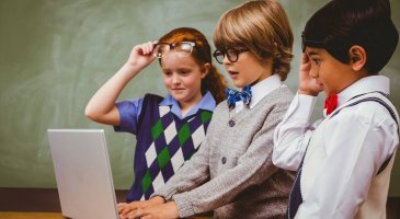 Little school kids using laptop in the classroom